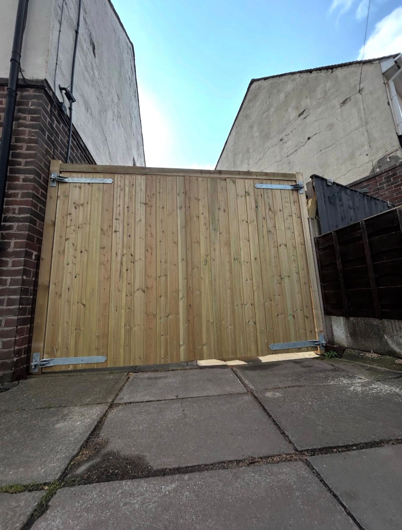 Completed bespoke timber driveway gates installation
