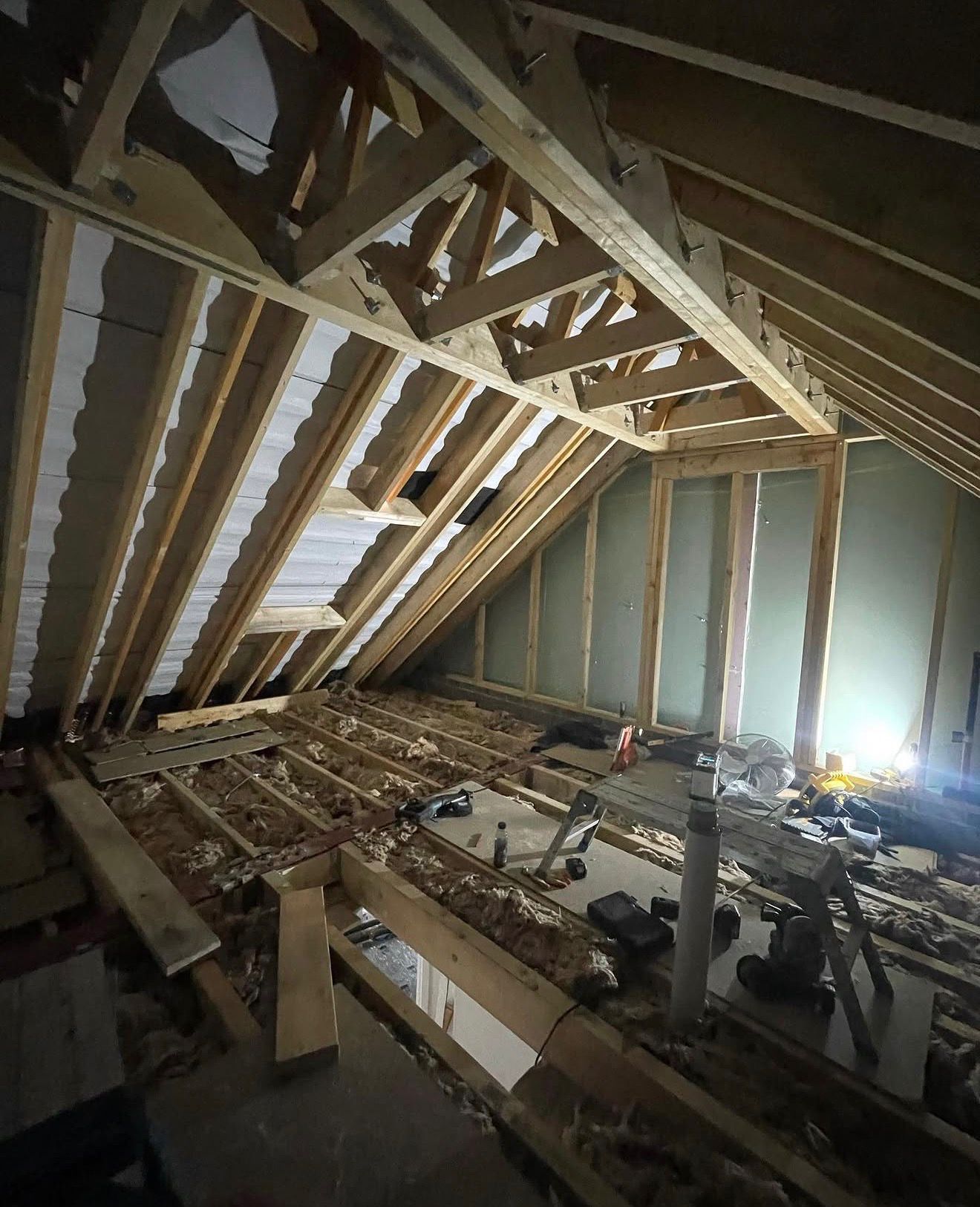 Rochdale loft conversion roof trusses being modified for headroom