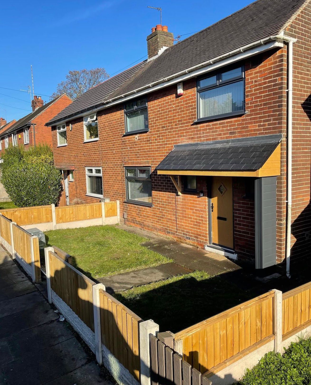 Property revamp with new windows, doors, door canopy and fencing — frontage