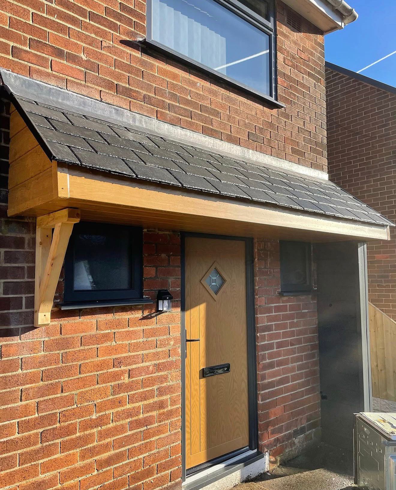 Completed property revamp showing new door canopy and fencing detail
