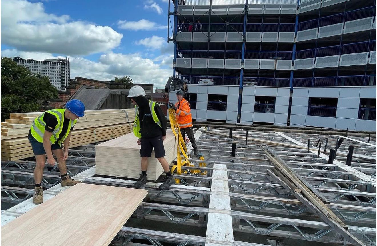 Timber-framed roof extension construction for apartment block