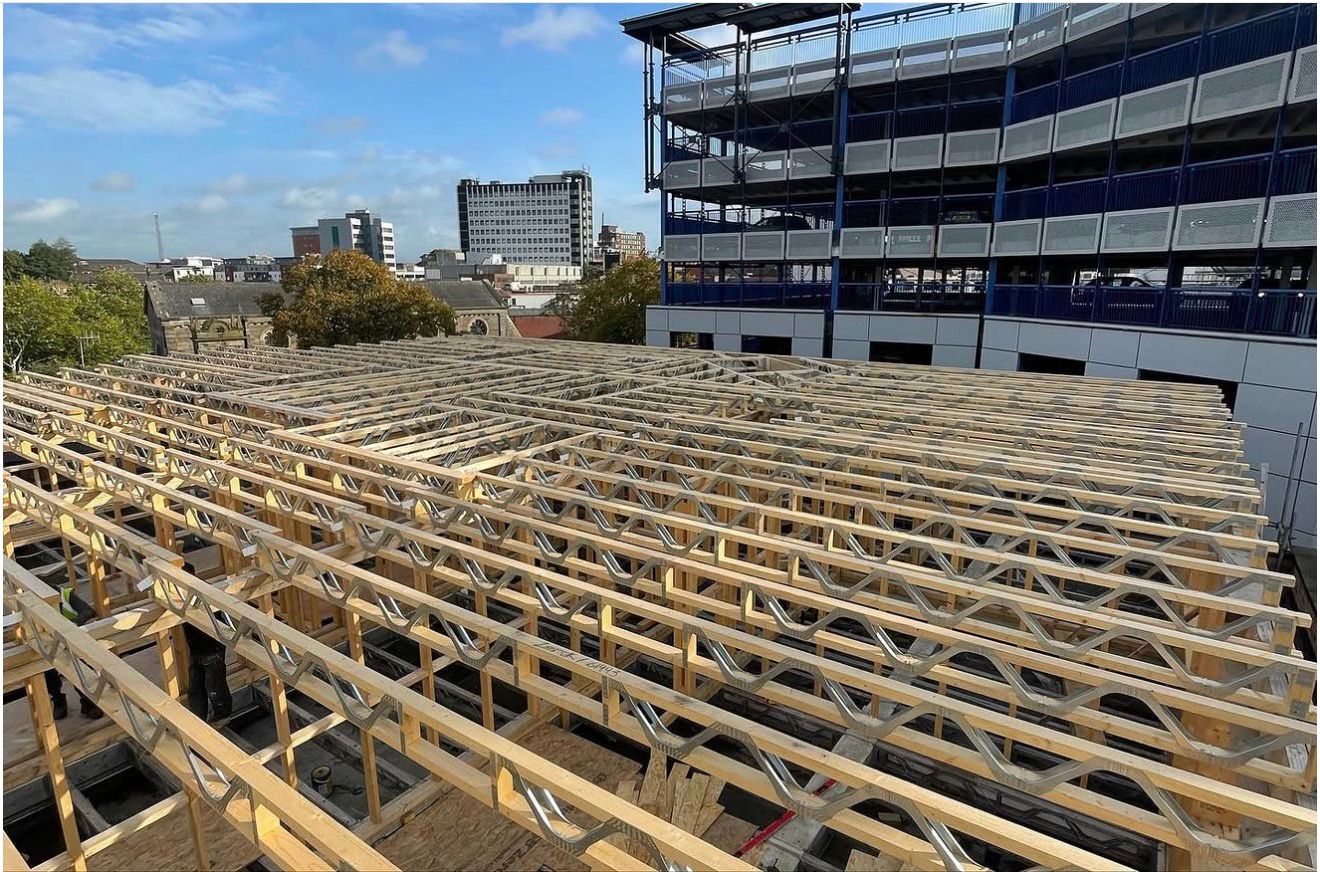 Completed timber-framed roof extension shell for apartments