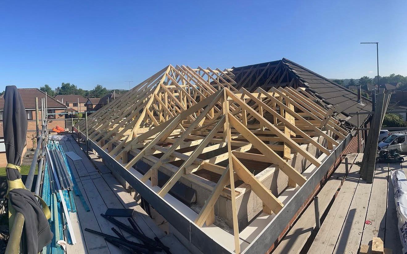 Structural roof trusses being lifted into place